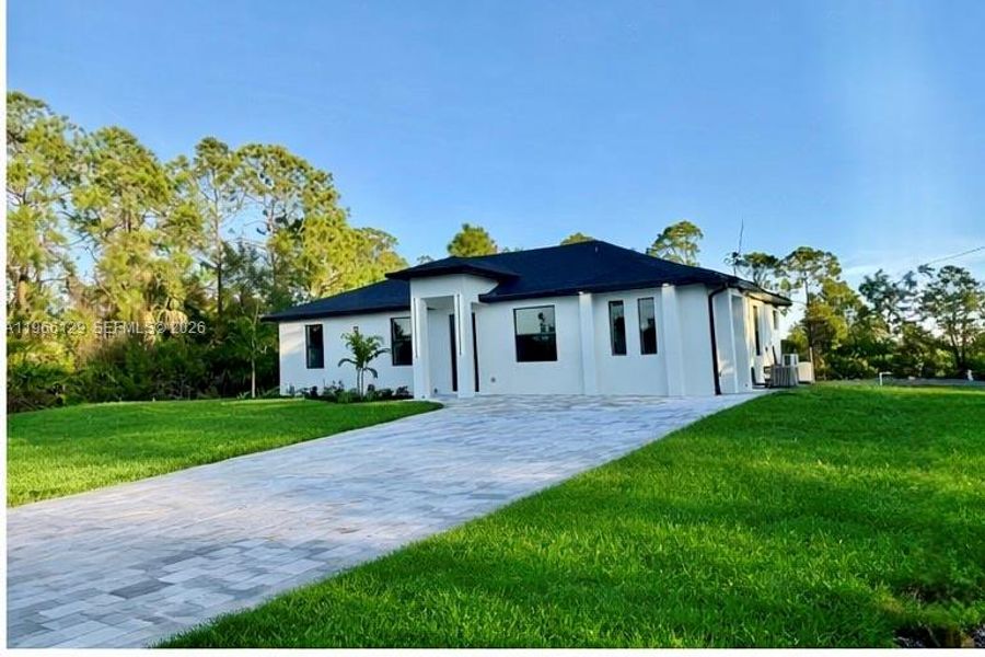 Front exterior of a new home in , Lehigh Acres, FL, highlighting curb appeal (Image 1). Front exterior of a new home in , Lehigh Acres, FL, highlighting curb appeal (Image 1).
