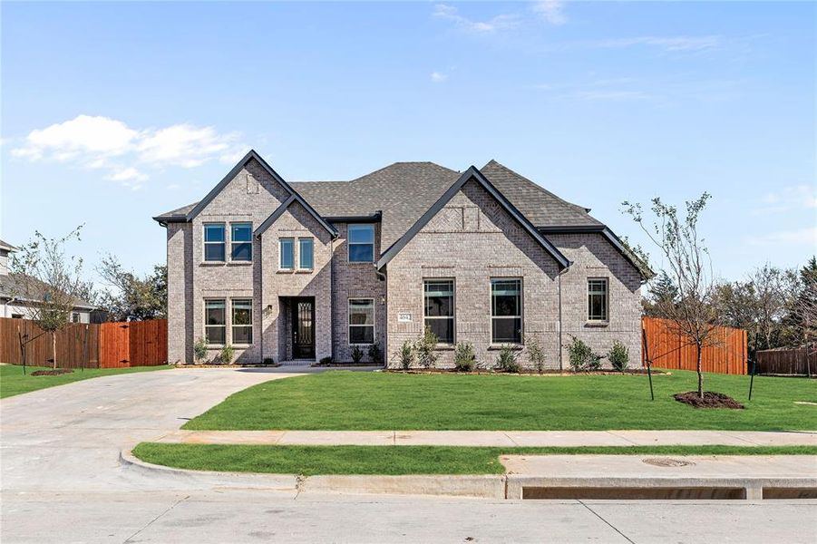 Front exterior of a new home in Ridgepoint, Midlothian, TX, highlighting curb appeal (Image 2). Front exterior of a new home in Ridgepoint, Midlothian, TX, highlighting curb appeal (Image 2).