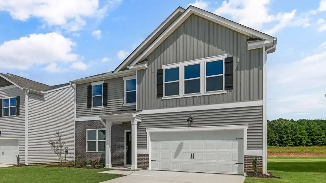 Front exterior of a new home in Olive Branch, Wilson's Mills, NC, highlighting curb appeal (Image 2). Front exterior of a new home in Olive Branch, Wilson's Mills, NC, highlighting curb appeal (Image 2).