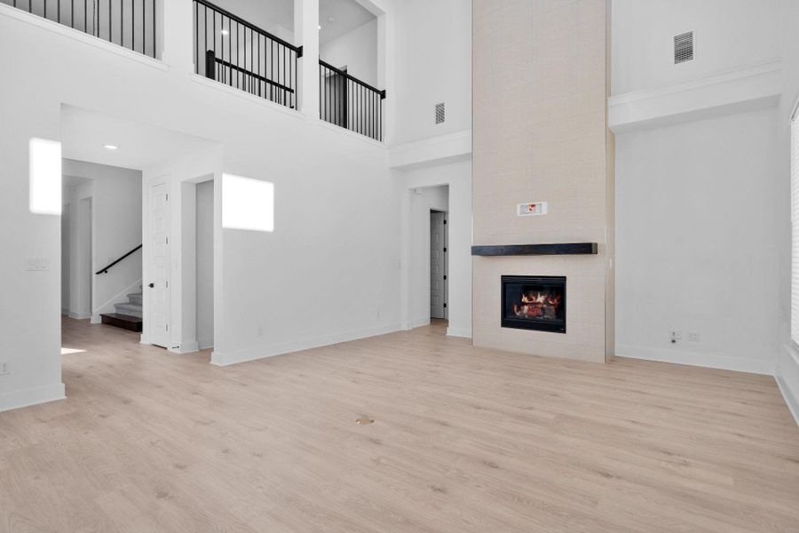 Family Room with soaring ceiling & fireplace