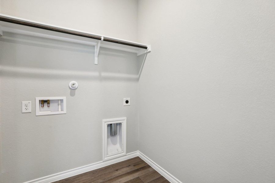 Washroom with dark wood finished floors, hookup for an electric dryer, washer hookup, and hookup for a gas dryer Washroom with dark wood finished floors, hookup for an electric dryer, washer hookup, and hookup for a gas dryer