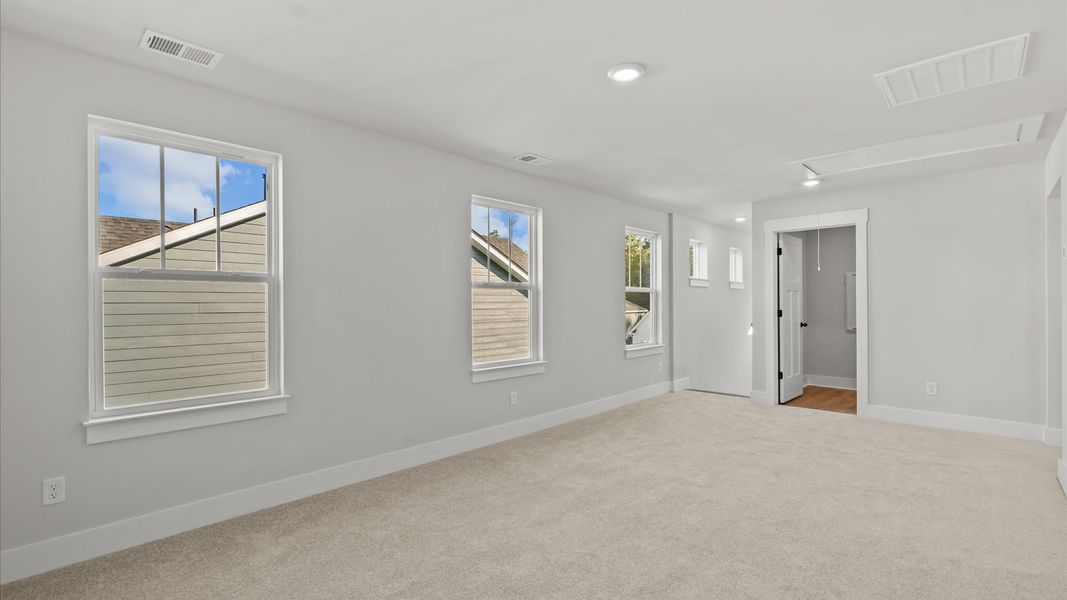 Elegant primary suite with tray ceiling and walk-in closet in this top-notch Hickory Heights townhome