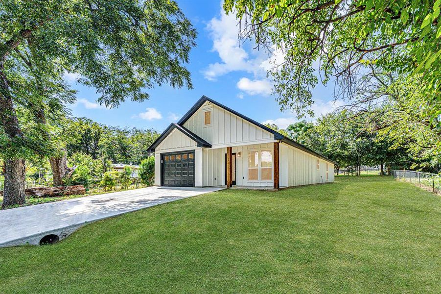 Modern farmhouse with driveway and board and batten siding Modern farmhouse with driveway and board and batten siding
