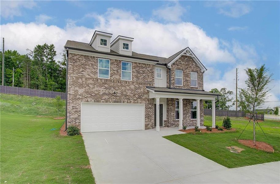 Front exterior of a new home in Kingsmere Estates, Loganville, GA, highlighting curb appeal (Image 2).