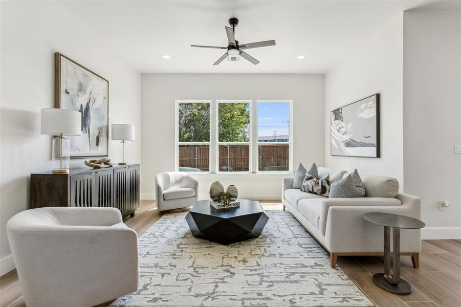 Living room featuring ceiling fan and light wood-type flooring