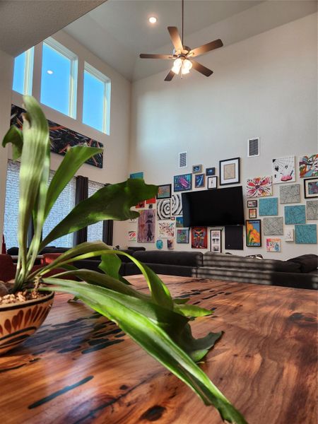Lofty ceilings elevate this spacious living area, featuring high-set windows for abundant natural light.