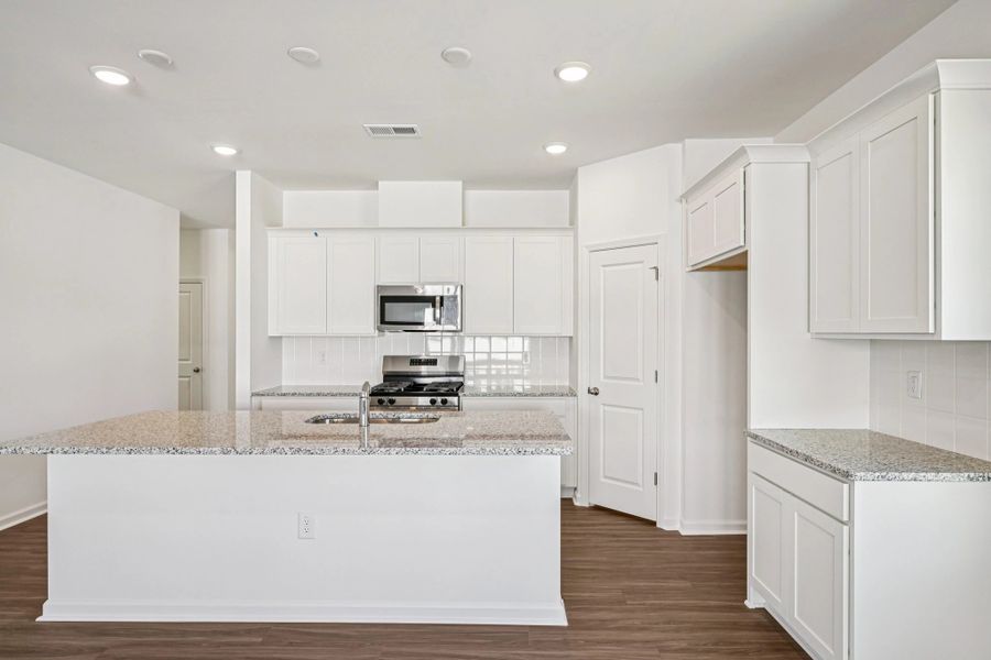 Kitchen - Chic white finishes and smooth surfaces shine.