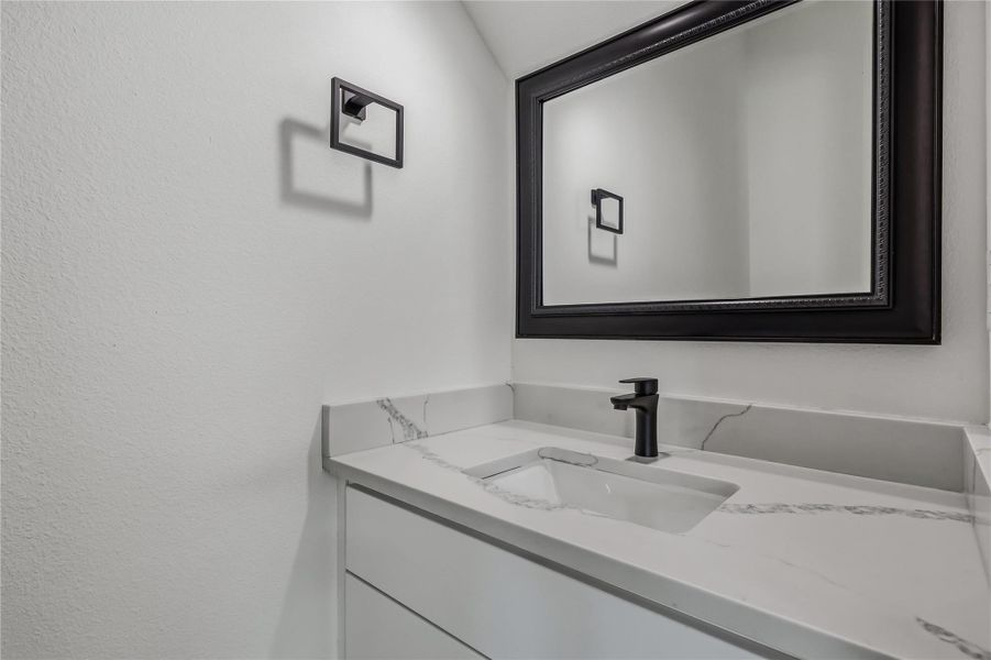 Main level powder bathroom adjacent to living room