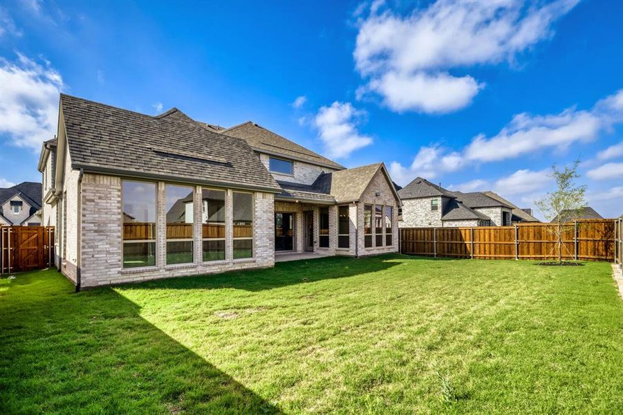 Rear view of property with a patio area, a fenced backyard, brick siding, and a residential view Rear view of property with a patio area, a fenced backyard, brick siding, and a residential view