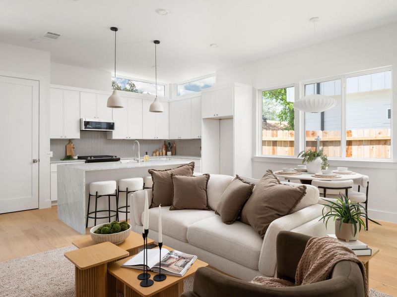 An open concept living area seamlessly connects a modern kitchen to a comfortable lounge space.
