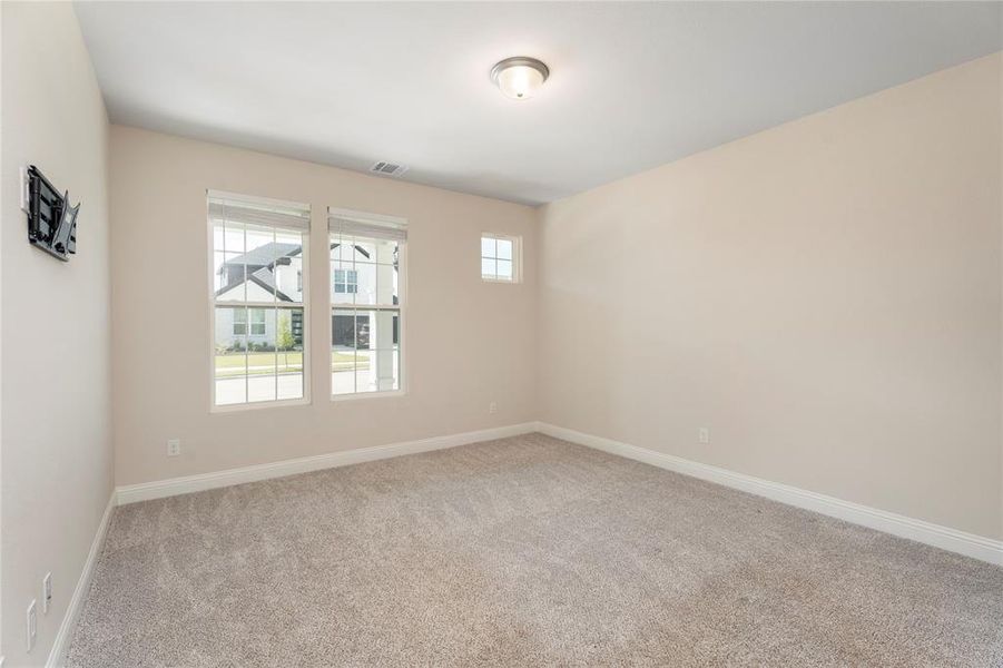 Unfurnished room featuring carpet floors and baseboards