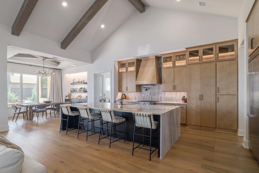 Designed for both form and function, the kitchen offers generous prep space, elevated finishes, and seamless connectivity to the dining area.