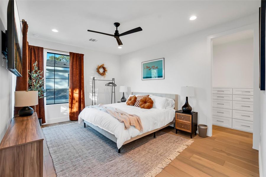Bedroom with light wood-style floors, a ceiling fan, and recessed lighting Bedroom with light wood-style floors, a ceiling fan, and recessed lighting