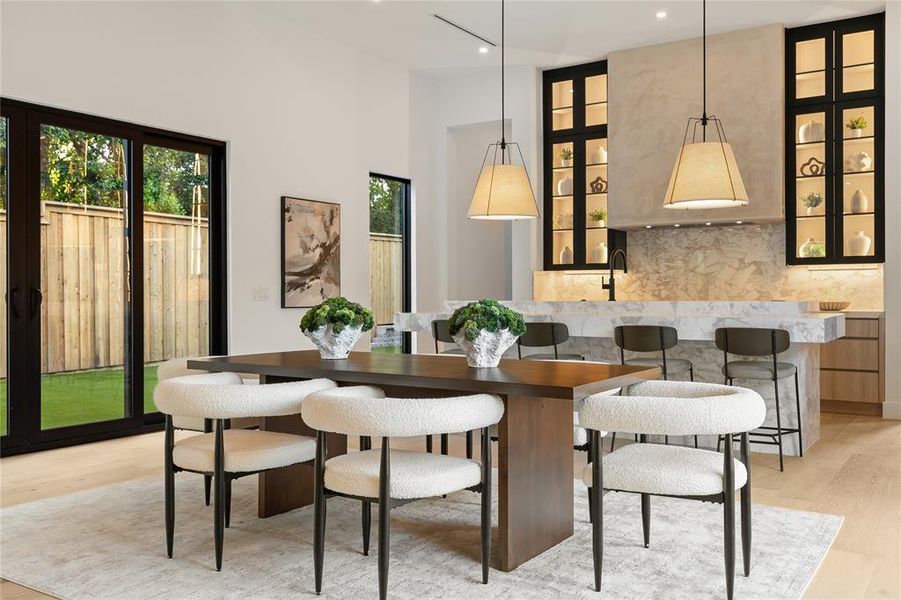 Open-concept dining area featuring light wood-finish flooring Open-concept dining area featuring light wood-finish flooring