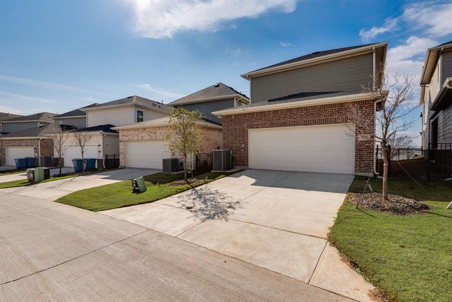 Front exterior of a new home in Bayside, Rowlett, TX, highlighting curb appeal (Image 1). Front exterior of a new home in Bayside, Rowlett, TX, highlighting curb appeal (Image 1).