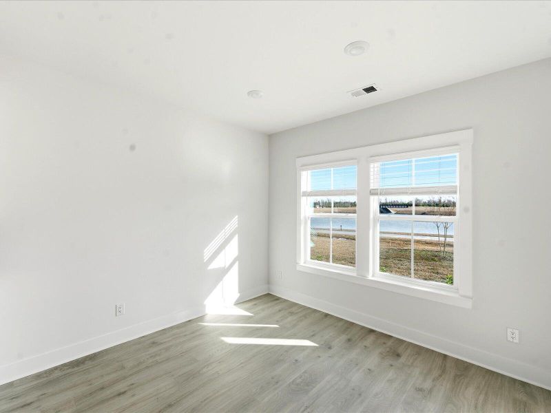 Spacious, unfurnished interior of a new home in The Coves at Lakes of Cane Bay II, Summerville (Image 38).
