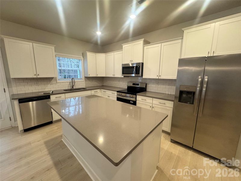 spacious kitchen island featuring cement quartz