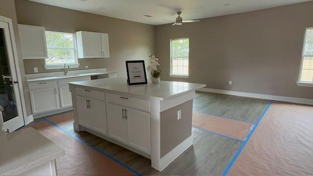 Kitchen featuring white cabinets, light countertops, and light wood-type flooring