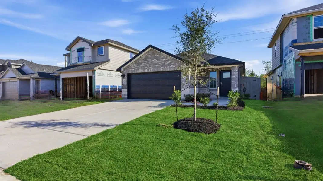 Front exterior of a new home in Lakes at Westland Ranch, League City, TX, highlighting curb appeal (Image 2).