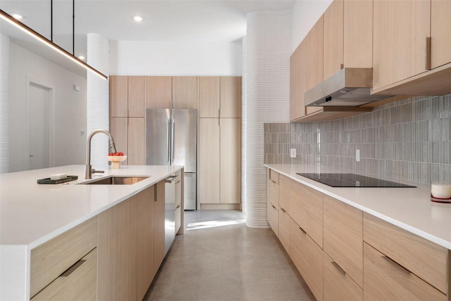 Kitchen with light brown cabinets and sink