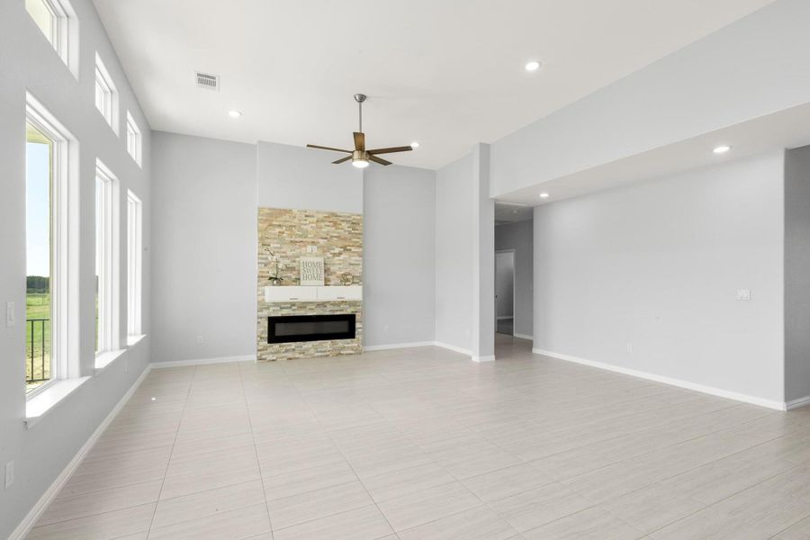 Unfurnished living room featuring a ceiling fan, a glass covered fireplace, and recessed lighting Unfurnished living room featuring a ceiling fan, a glass covered fireplace, and recessed lighting