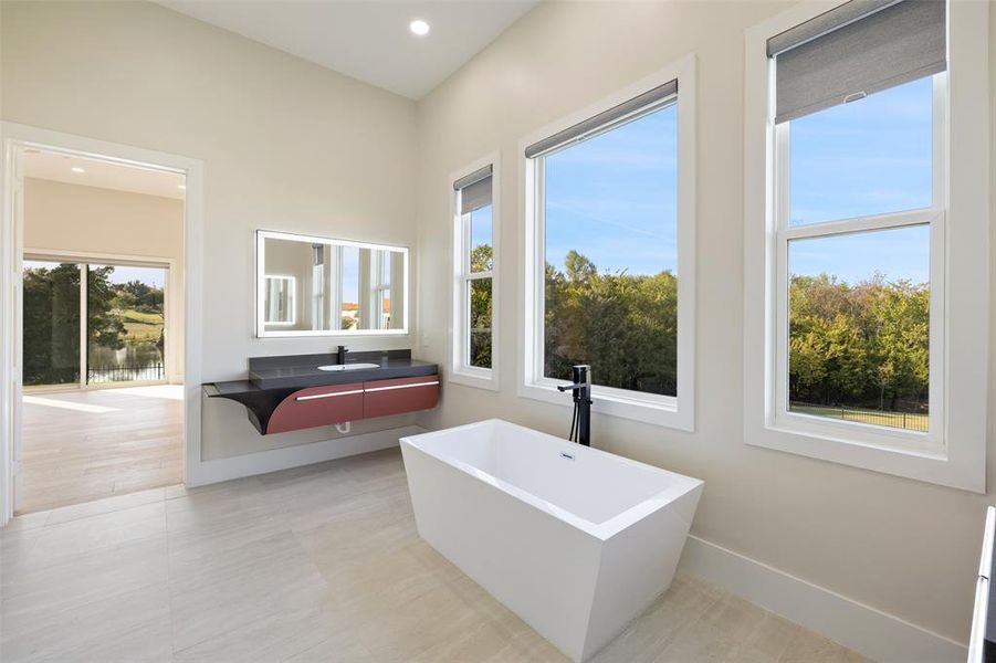 Bathroom with vanity, a bathing tub, and hardwood / wood-style flooring