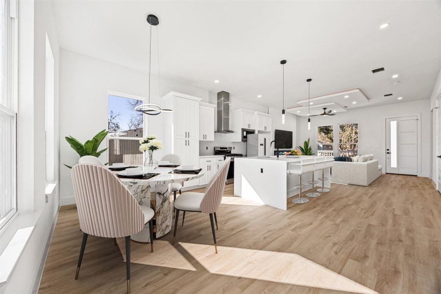 Dining area, virtually staged, looking on to the rest of the common area.