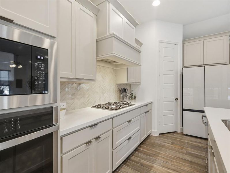 You will enjoy the gorgeous backsplash and gas range for cooking!