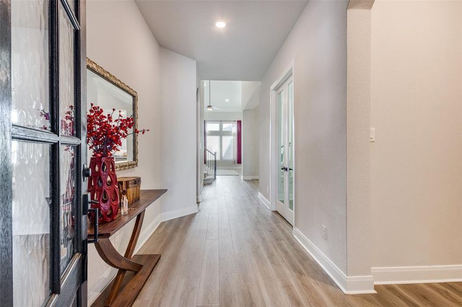 Corridor featuring light wood finished floors and recessed lighting