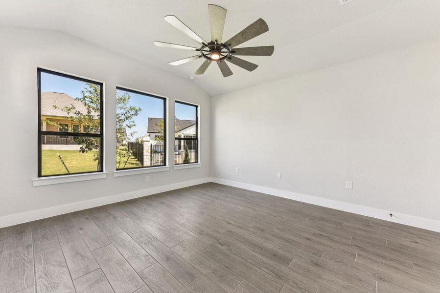 Spare room with vaulted ceiling and light wood-style floors Spare room with vaulted ceiling and light wood-style floors