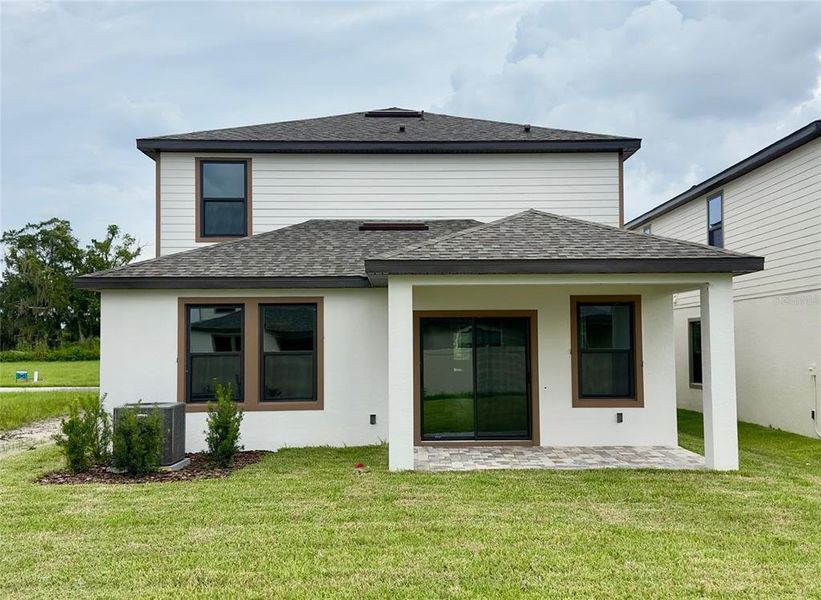 Front exterior of a new home in Grasslands West, Lakeland, FL, highlighting curb appeal (Image 20).