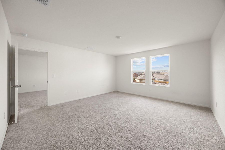 Unfurnished room with light colored carpet and baseboards
