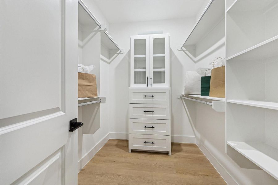 Walk-in closet with custom shelving and storage Walk-in closet with custom shelving and storage