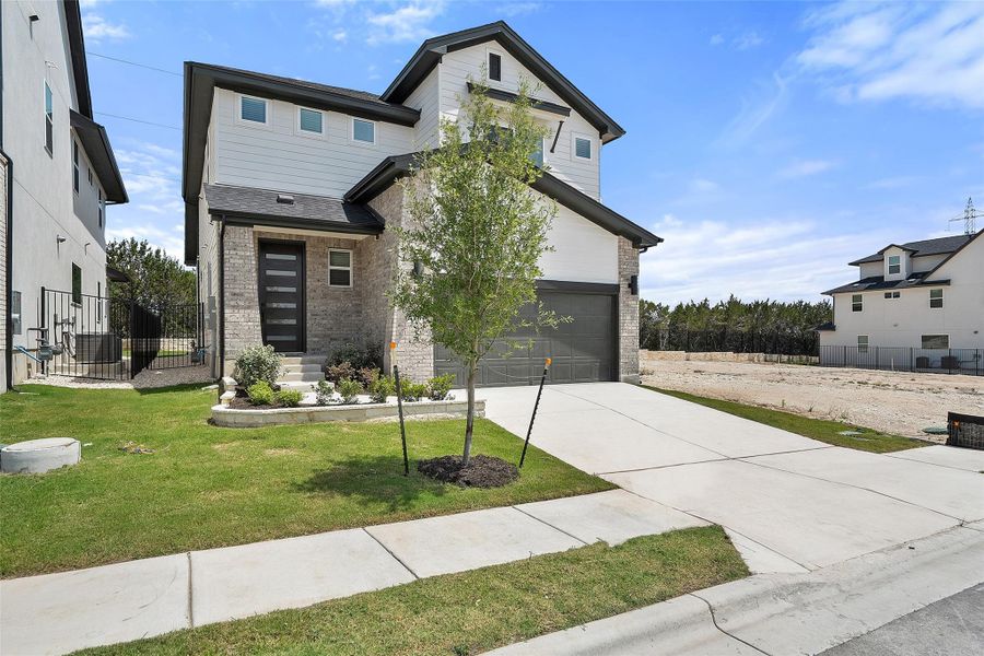 Front exterior of a new home in Foxfield, Austin, TX, highlighting curb appeal (Image 1). Front exterior of a new home in Foxfield, Austin, TX, highlighting curb appeal (Image 1).