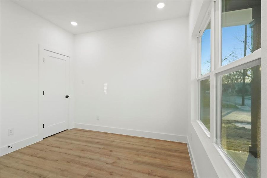 Unfurnished room featuring wood finished floors and recessed lighting