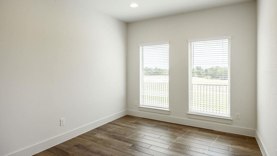 Unfurnished room with dark wood-type flooring and baseboards