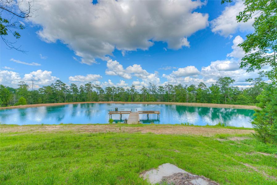 Huge beautiful pond with a pier and fish feeder for the pond that's stocked with thousands of catfish (Building B) Huge beautiful pond with a pier and fish feeder for the pond that's stocked with thousands of catfish (Building B)