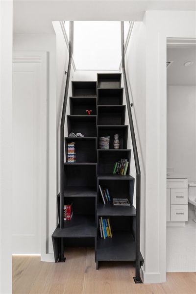 Stairway featuring wood finished floors and baseboards