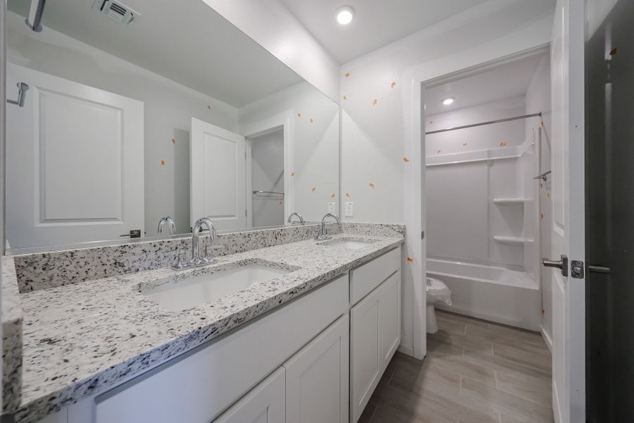 A bathroom with a marble countertop. A bathroom with a marble countertop.