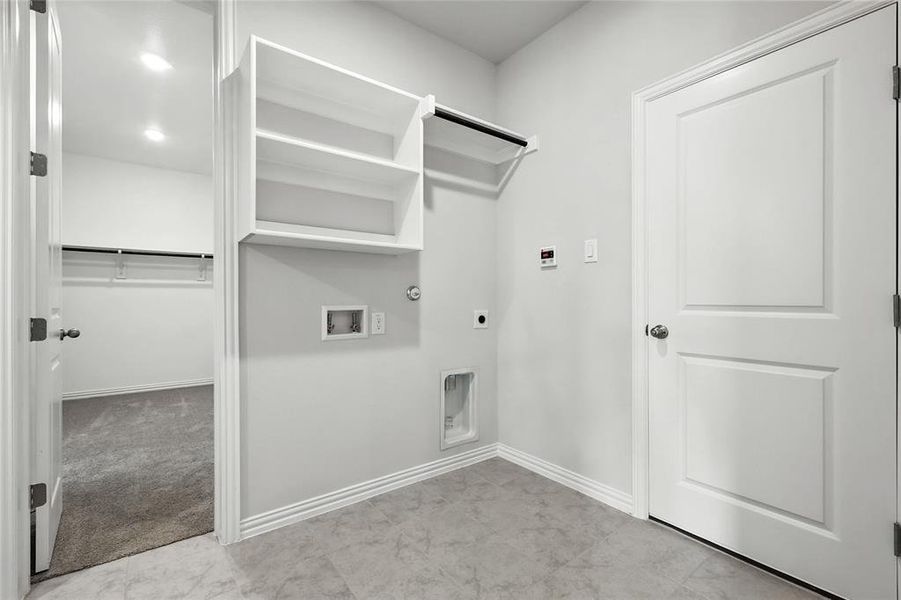 Laundry area featuring hookup for a gas dryer, hookup for an electric dryer, and hookup for a washing machine Laundry area featuring hookup for a gas dryer, hookup for an electric dryer, and hookup for a washing machine