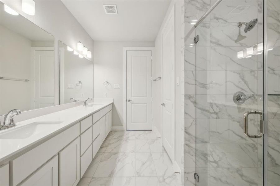 Primary Bathroom with an enclosed shower and vanity