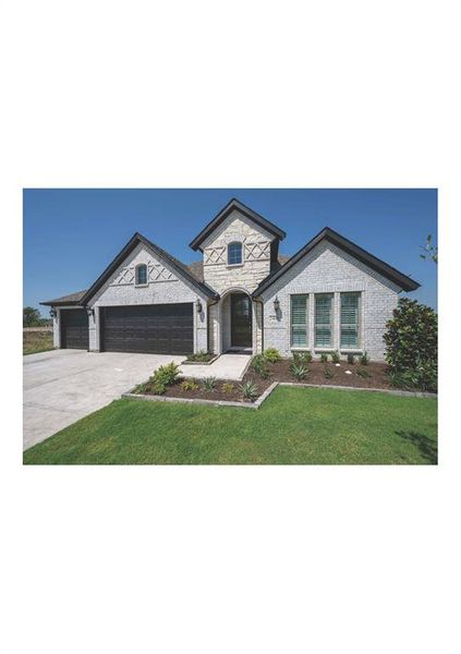 View of front of house with a front lawn and a garage