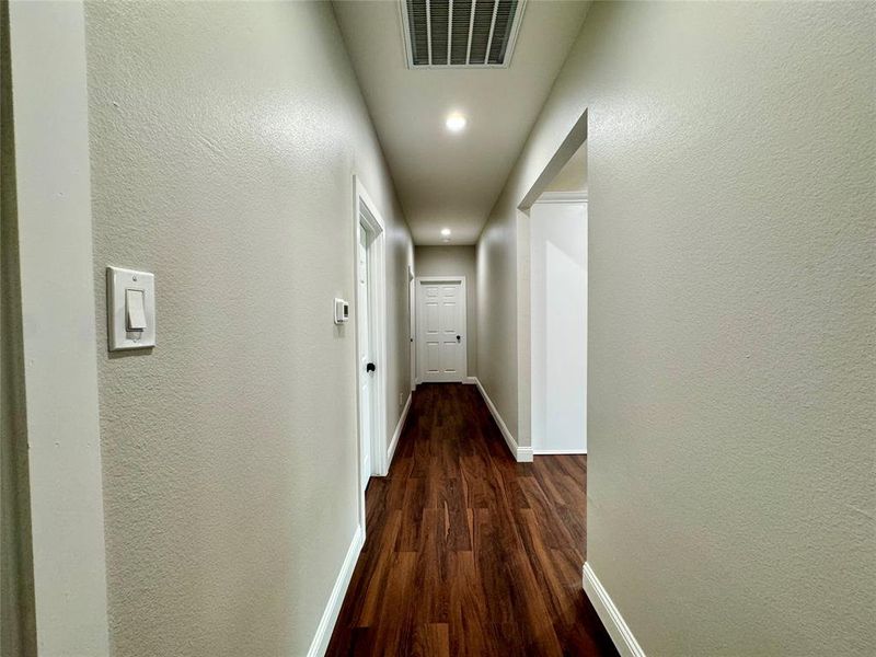 Hall with dark hardwood / wood-style floors