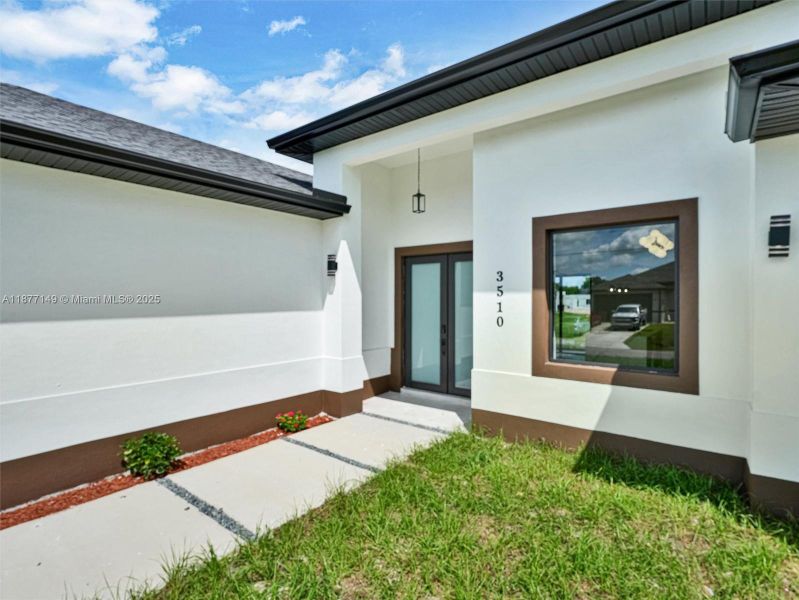 Front exterior of a new home in , Lehigh Acres, FL, highlighting curb appeal (Image 21).