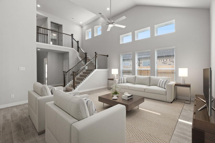 Bring the family and guests together in the welcoming family room! Enjoy the expansive space adorned with high ceilings, recessed lighting, a stylish ceiling fan, custom paint, exquisite flooring, and generously sized windows that fill the room with an abundance of natural light, creating a warm and inviting atmosphere for everyone to enjoy. The open stair case adds the final touch to this impressive space. Sample photo of completed home with similar floor plan. Actual colors and selections may vary. Bring the family and guests together in the welcoming family room! Enjoy the expansive space adorned with high ceilings, recessed lighting, a stylish ceiling fan, custom paint, exquisite flooring, and generously sized windows that fill the room with an abundance of natural light, creating a warm and inviting atmosphere for everyone to enjoy. The open stair case adds the final touch to this impressive space. Sample photo of completed home with similar floor plan. Actual colors and selections may vary.