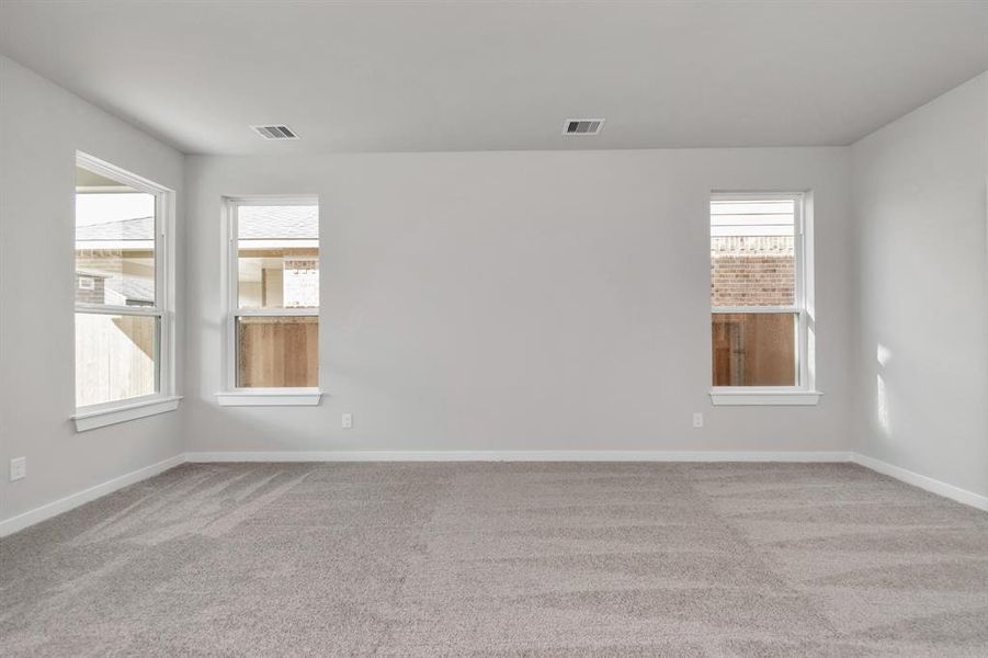 Large windows in the primary room for a bright and welcoming feel. Sample photo of completed home with similar floor plan. As-built interior colors and selections may vary.