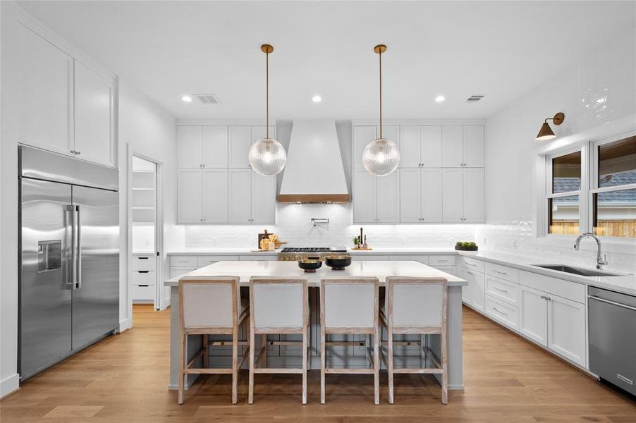 Beautiful chef's kitchen with 48" range and 48" built in fridge and windows overlooking backyard