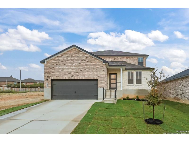 Front exterior of a new home in Comanche Ridge, San Antonio, TX, highlighting curb appeal (Image 1).