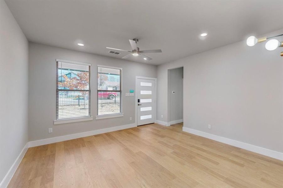 Empty room featuring light hardwood / wood-style flooring and ceiling fan