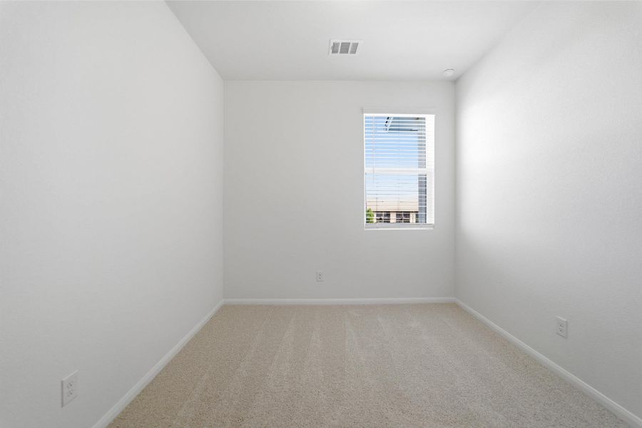 Spare room with light carpet and baseboards Spare room with light carpet and baseboards